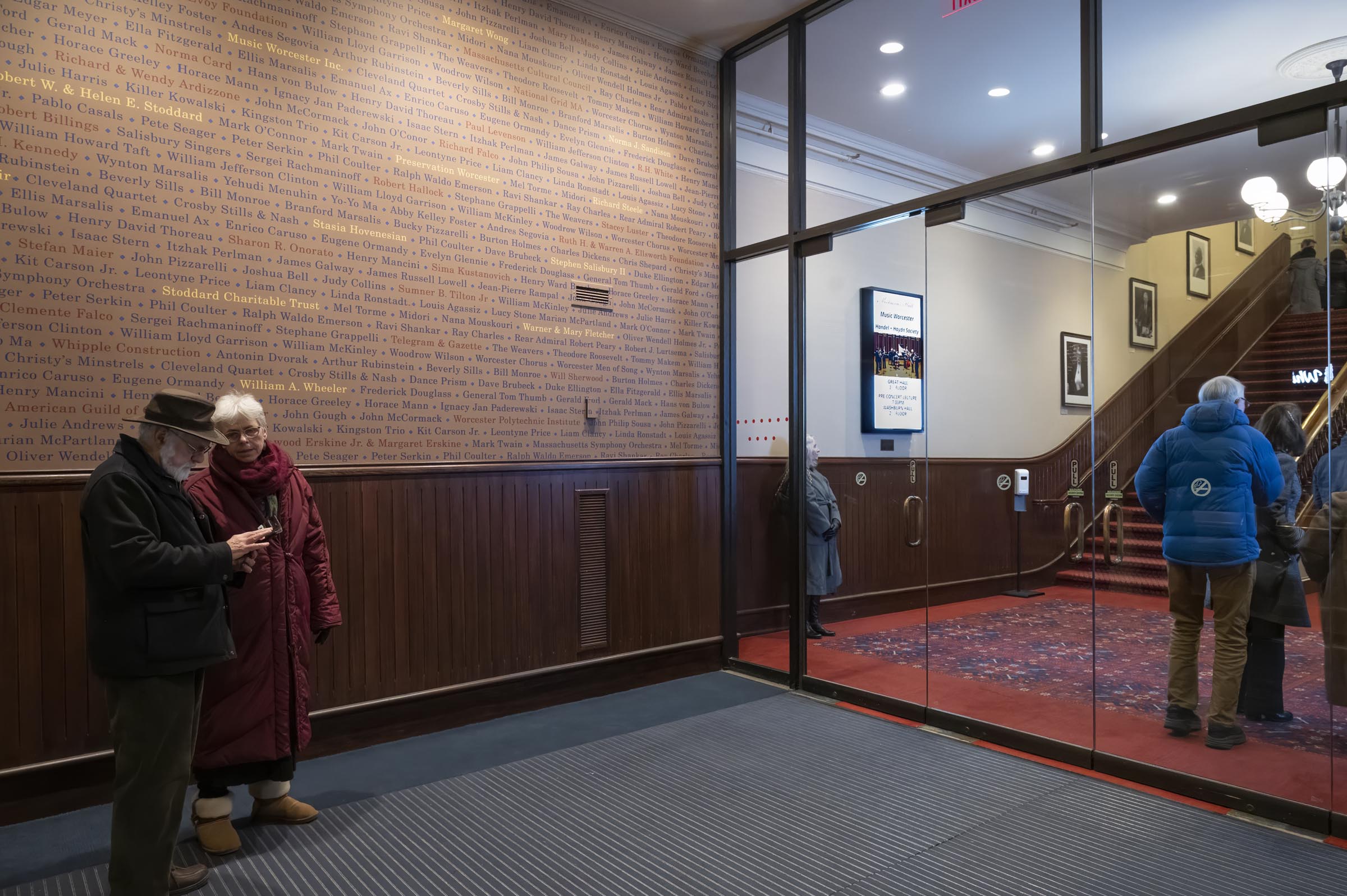 New outer lobby of Mechanics Hall with wainscoting and wallpaper, new digita messagin is visible through the glass