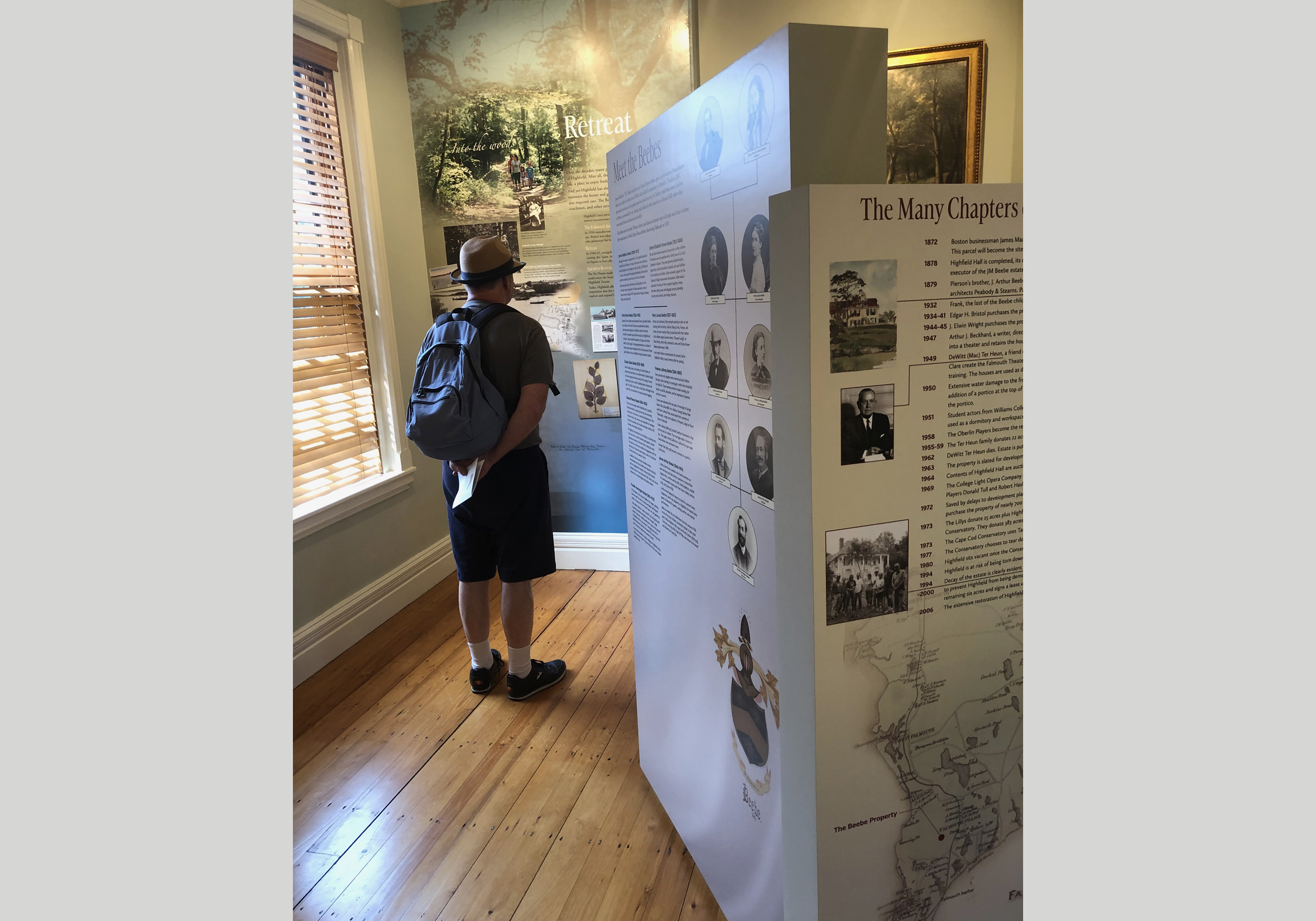 A man reading text in a museum gallery