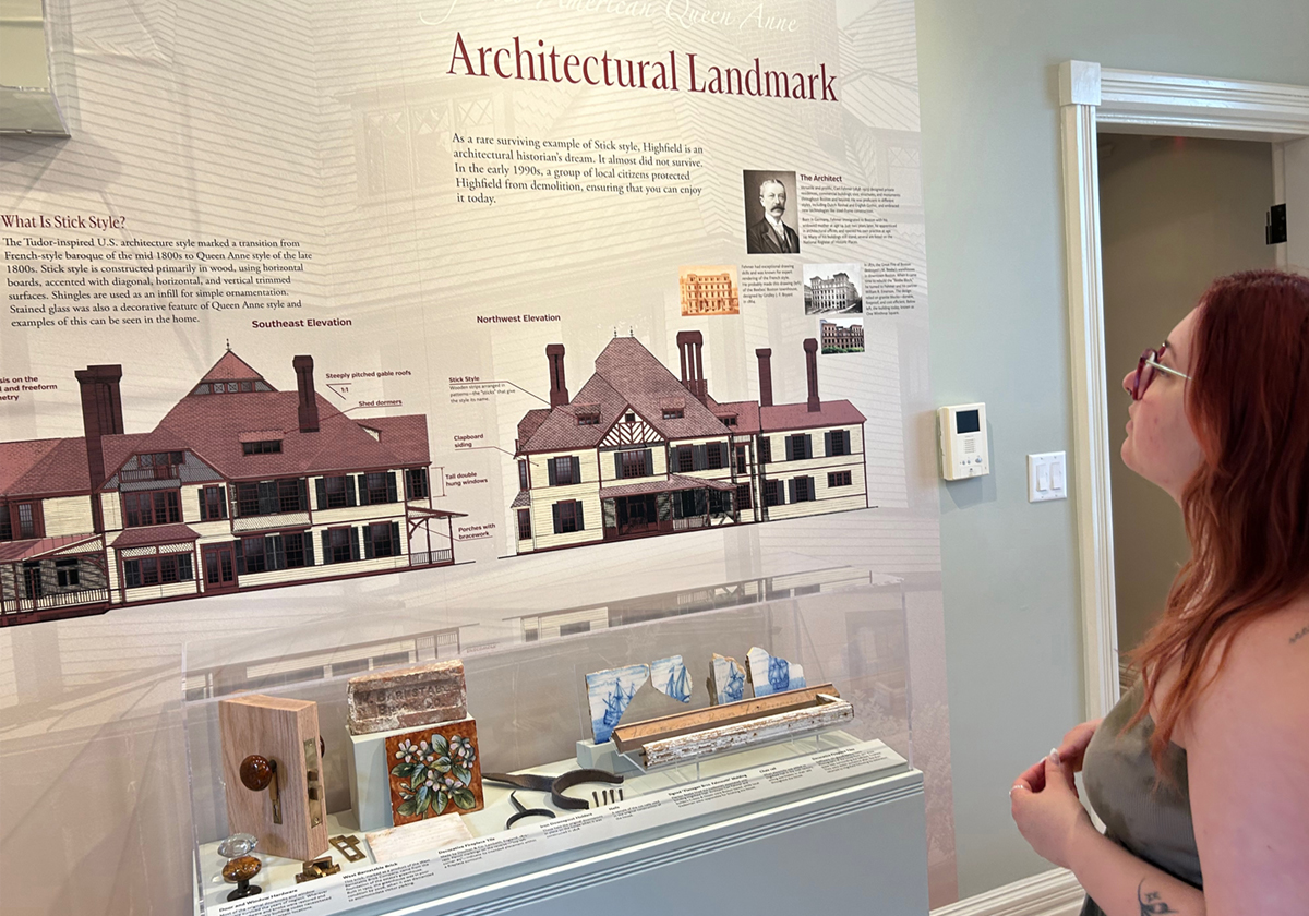 Woman reading text about an exhibit on architecture