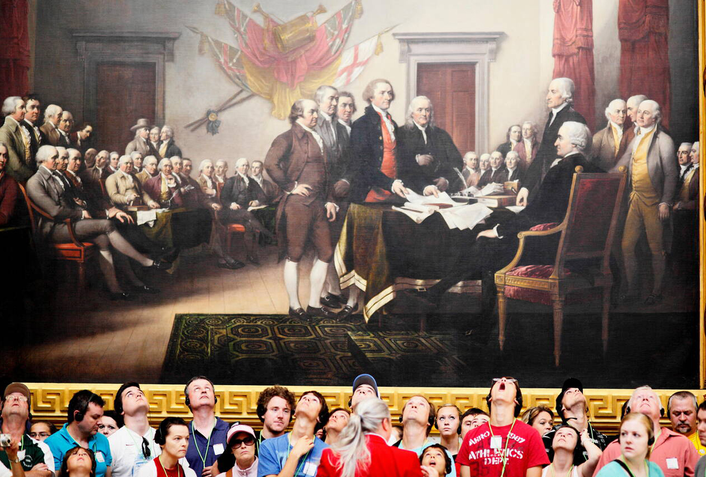 Visitors at the U.S. Capitol Rotunda in awe at John Trumbull's paintings, such as "Declaration of Independence."