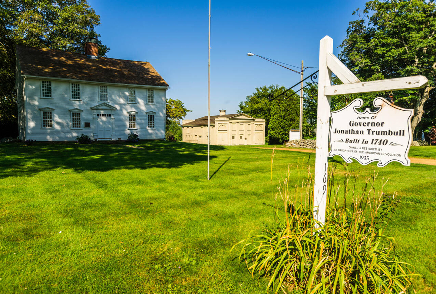 The Governor Jonathan Trumbull House (left) and the Wadsworth Stable (right), viewed from Lebanon Green on a sunny spring day.